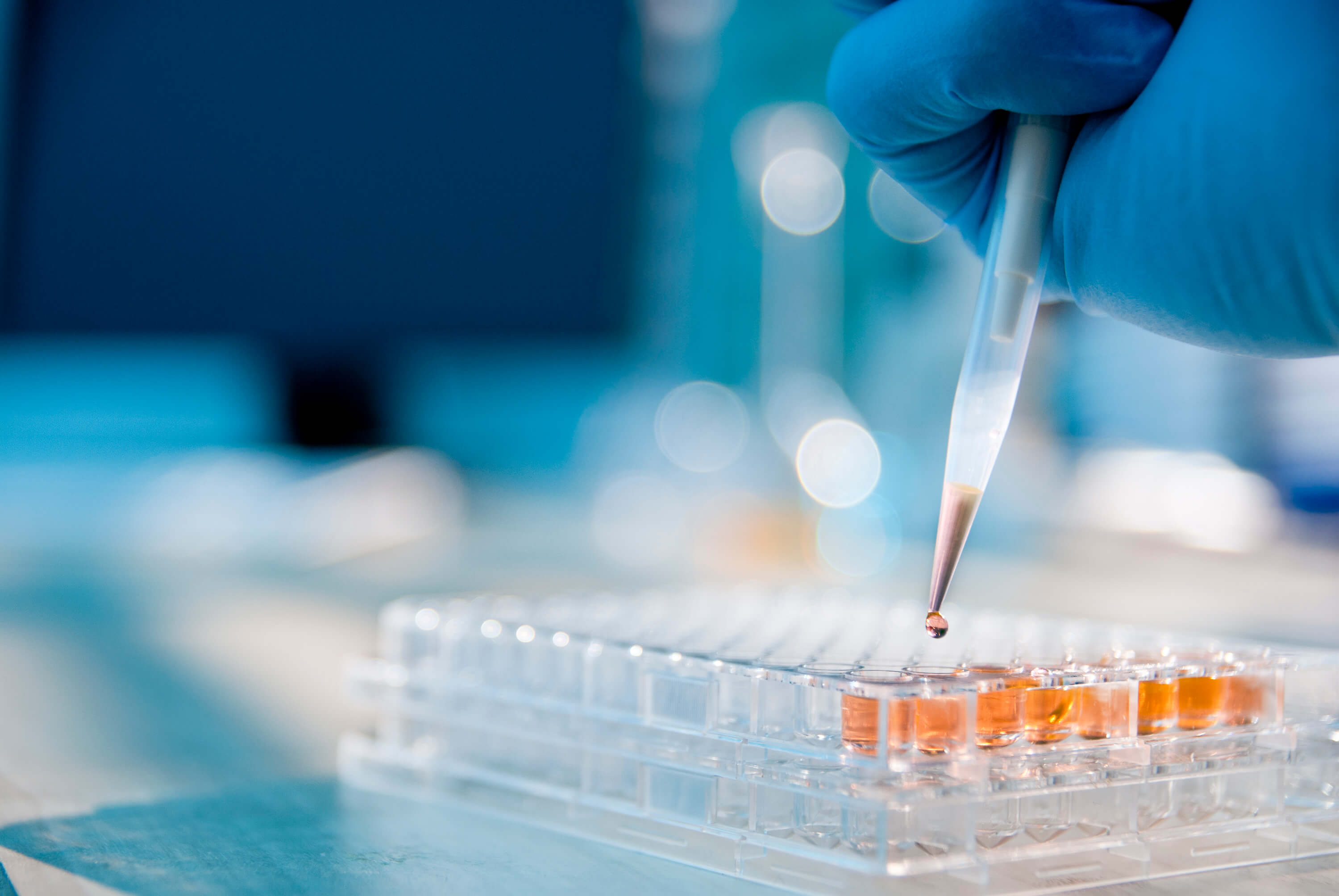 A researcher using a pipette